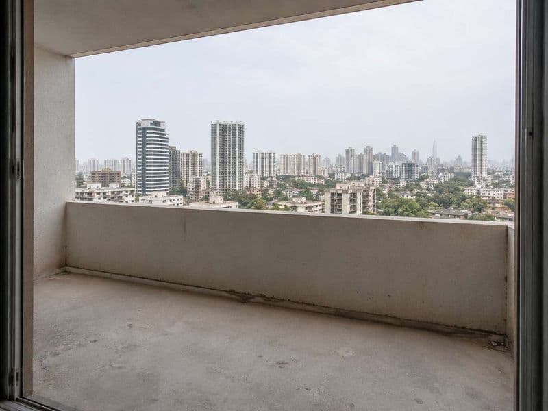 An open apartment balcony with only a low parapet and no safety barrier